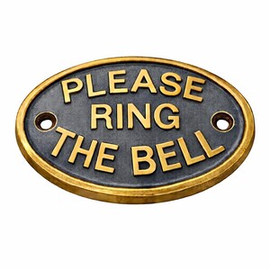 May include: An oval-shaped metal sign with a dark grey textured background and a raised gold-coloured border. The sign features the embossed gold-coloured text "PLEASE RING THE BELL" and includes two circular mounting holes on the left and right sides. marine door plaque, marine wall decor, marine home decor, marine door decor, marine entry sign, marine decor, boat door sign, boat door plaque, boat entry sign, boat entry plaque, boat wall plaque, boat wall decor, boat cabin sign,