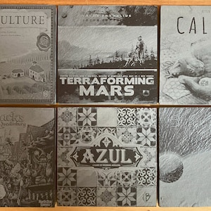 May include: Six different board game boxes with black and white images. The boxes are arranged in two rows of three. The top row features the games "Viticulture", "Terraforming Mars", and "Calico". The bottom row features the games "Quacks of Quedlinburg", "Azul", and a game with a black and white image of a wave.