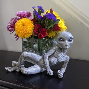 Alien Invasion 10” Long Male Lying UFO Extraterrestrial Garden Alien Statue and Figurine “Storm” – Alien Gray