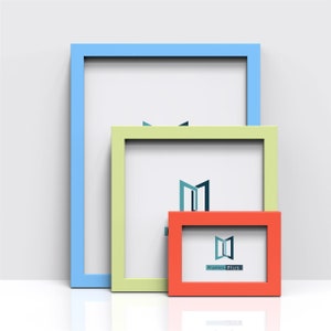 May include: Three picture frames nested inside each other. The largest frame is light blue, the middle frame is light green, and the smallest frame is orange. The frames are all empty and have a white background. The logo "Frames Plus" is visible in the smallest frame.