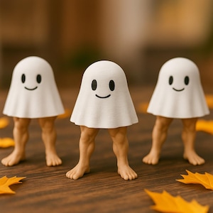 May include: Three whimsical Halloween figurines. Each figure features a white ghost-like body with a smiling face and tan-colored legs and feet. The figurines are arranged on a wooden surface with scattered orange leaves.