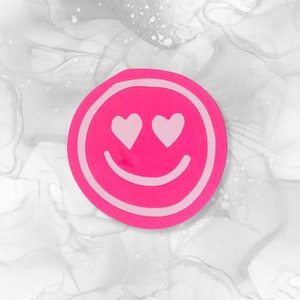 Etiqueta engomada de la etiqueta rosada de la cara sonriente