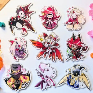 May include: Ten colourful cartoon character stickers with red, pink, yellow, black and white accents. The characters are all wearing different outfits and have different expressions. The stickers are on a white background.