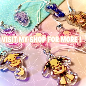 May include: A collection of eight clear acrylic charms featuring various illustrated creatures with glitter accents, each attached to a white cord loop. The charms display diverse colors including yellow, blue, and pink. The text VISIT MY SHOP FOR MORE ! is overlaid in the center.