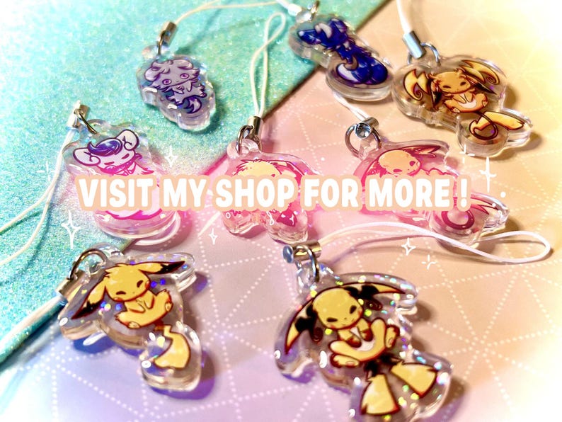 May include: A collection of eight clear acrylic charms featuring various illustrated creatures with glitter accents, each attached to a white cord loop. The charms display diverse colors including yellow, blue, and pink. The text VISIT MY SHOP FOR MORE ! is overlaid in the center.
