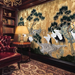 May include: A luxurious library with dark wood bookshelves filled with books. A red leather armchair sits in front of a wall mural depicting cranes and a landscape scene. A lamp sits on a small table.