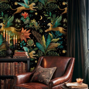 May include: A room with black wallpaper depicting winged leopards, tropical plants, and a night sky. A brown leather armchair, a small side table, and a bookshelf filled with books are in the room. The room also has a dark green curtain.