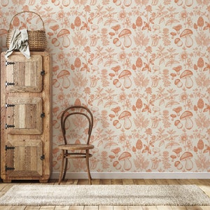 May include: A vintage-style wooden cabinet with two doors and a drawer, a wooden chair, and a beige rug in front of a wall with a repeating pattern of orange mushrooms and foliage.