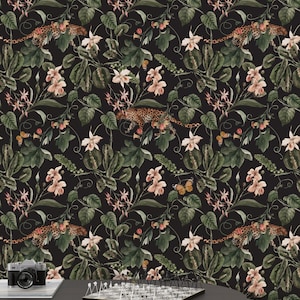 May include: A black and white wallpaper with a repeating pattern of pink flowers, green leaves, and leopard print animals. The wallpaper is shown in a room with a chessboard and a camera on a table.
