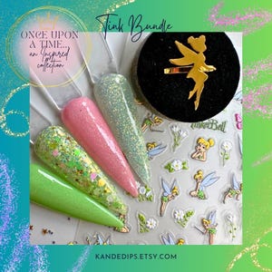 May include: A nail art bundle featuring four glitter nail swatches in green, pink, and silver, a gold-colored ring with a fairy design, and fairy-themed nail stickers. The text "Tink Bundle" and "Once Upon a Time... an Inspired collection" are visible.