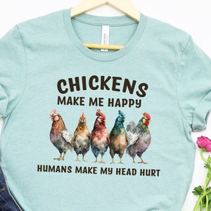 May include: A light blue t-shirt with a graphic of five chickens and the text "Chickens make me happy, Humans make my head hurt."