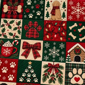 May include: A quilted throw blanket featuring a grid of festive squares with holiday themes including a golden dog, a black dog, paw prints, bones, Christmas trees, snowflakes, a red mug with a candy cane, a dog house, and a poinsettia flower.