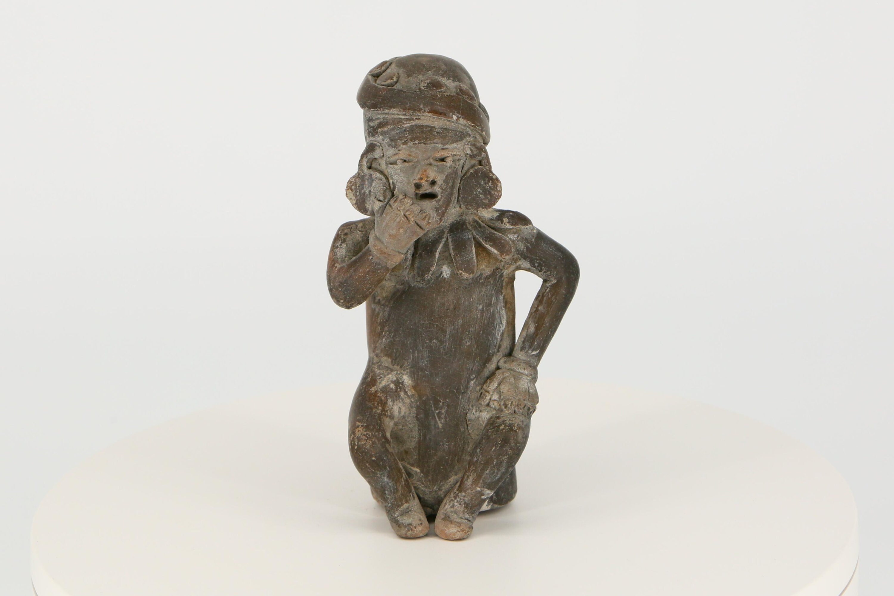 Vintage pre-Columbian figurine from Ecuador. Replica of an ancient Mayan statuette.
