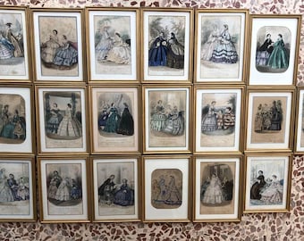May include: A collection of framed antique prints depicting women in elaborate dresses. The prints are in gold frames and feature scenes with multiple figures. The artwork is in a vintage style, with soft colors and detailed illustrations.