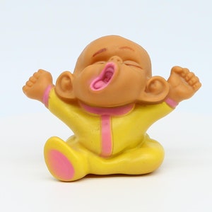 Baby doll in yellow pajamas. Pere