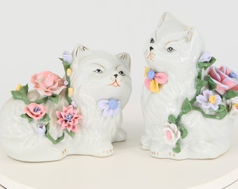 Figures of cats with flowers