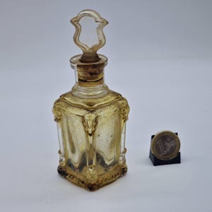 Vintage perfume or liquor bottle in decorative pressed glass Art Nouveau style