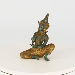 Bronze figure of a Thai musician with plates