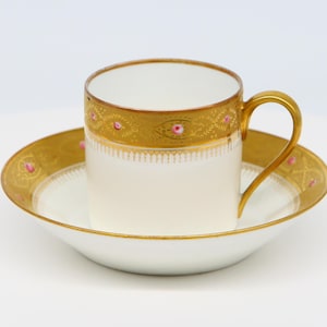 Cup and saucer with gold pattern