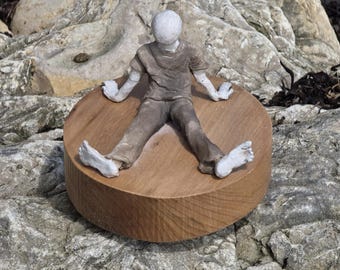 Ceramic handmade sculpture raku fired, seated male figure on wood base