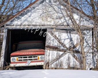 Photo of an old red truck in a rustic garage taken on a winter day in Wisconsin. Old vintage truck. Antique truck. Old vehicle in garage.