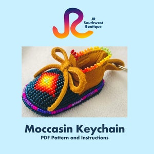 May include: A beaded moccasin keychain with a rainbow coloured bead trim and a brown leather base. The keychain is a DIY craft project with a PDF pattern and instructions.  JR Southwest Boutique.