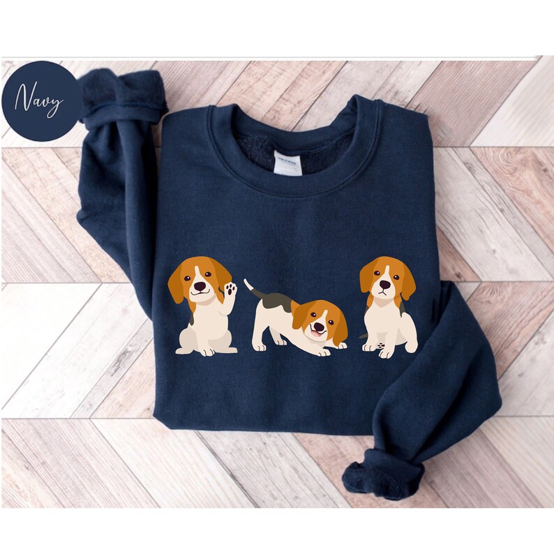 May include: Navy blue sweatshirt with a graphic of three beagle puppies. The puppies are in different poses, one is sitting, one is standing and one is laying down.