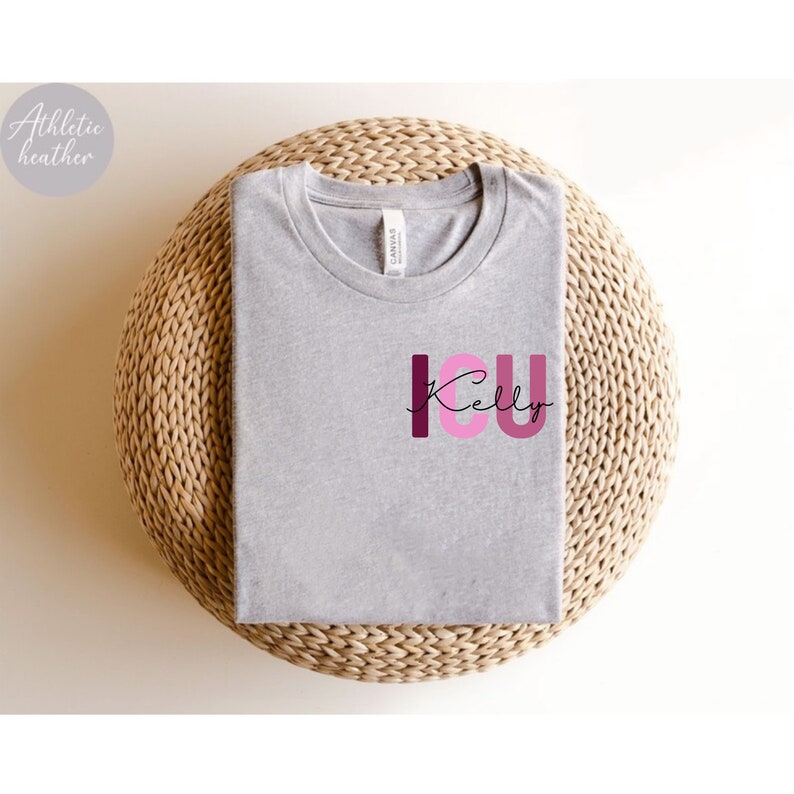 May include: A gray t-shirt with the text "I.C.U. Kelly" in pink and burgundy letters.