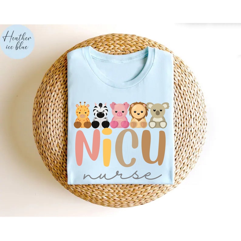 May include: Light blue t-shirt with a graphic of a line of cute animal characters and the text "NICU nurse".