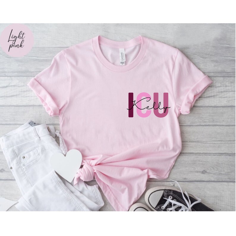 May include: A light pink t-shirt with the text "ICU Kelly" in pink and burgundy letters.