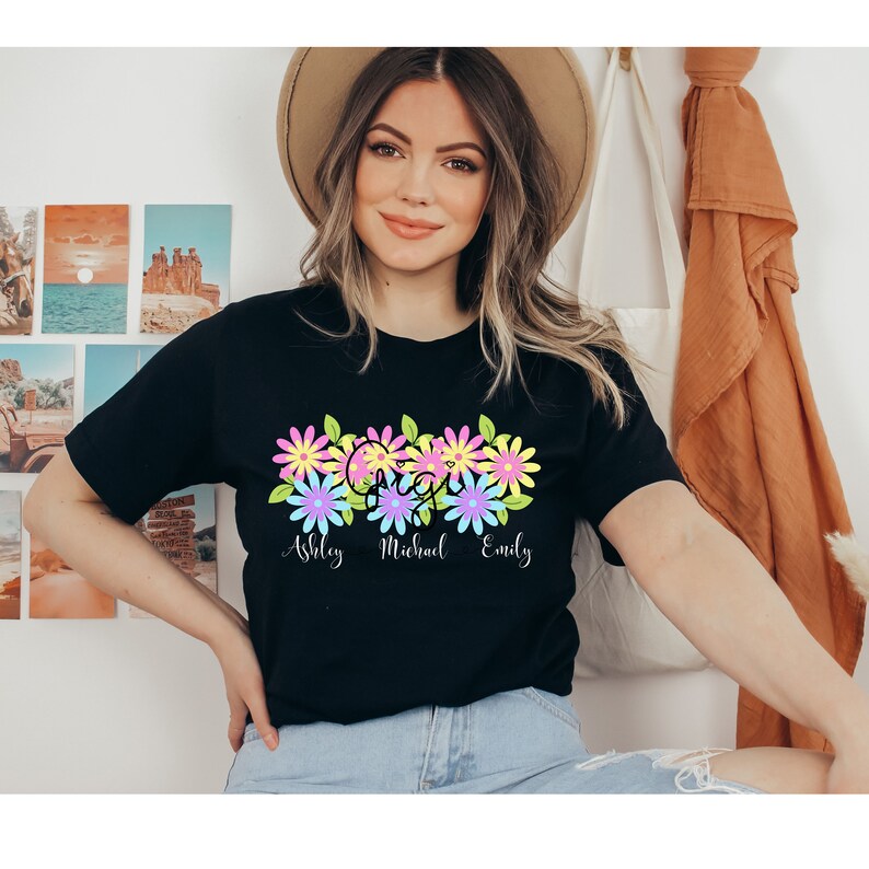 May include: Black t-shirt with a floral design and the names "Ashley", "Michael", and "Emily" printed below.