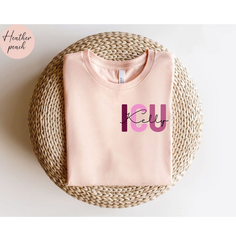 May include: A heather peach t-shirt with the text "ICU Kelly" in pink and burgundy letters.
