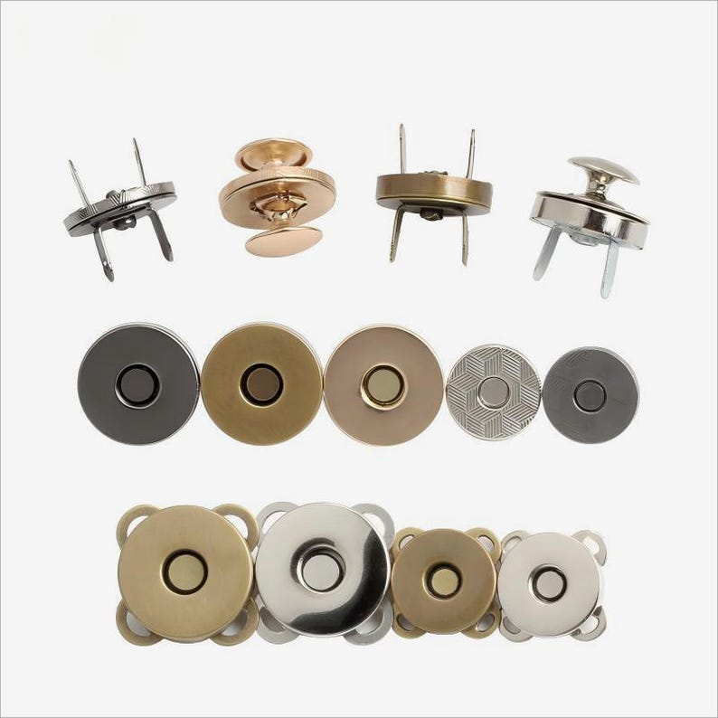 May include: Assortment of magnetic snap closures in various finishes, including silver, gold, and black. The snaps are in different sizes and styles, including round, square, and rectangular.