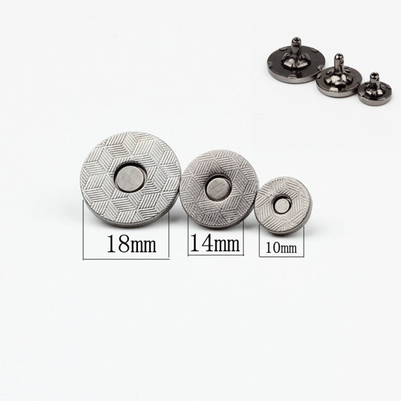 May include: Three silver magnetic snap closures in different sizes: 18mm, 14mm, and 10mm. The snaps have a textured, patterned surface.