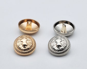 May include: Two sets of lion head buttons, one set is gold and the other is silver. Each button features a raised lion head design and a loop on the back for sewing.