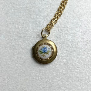SMALL Antique brass LOCKET with vintage glass Limoge BLUE rose cabochon in lace edge setting on 16" necklace.