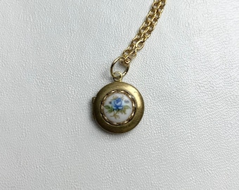 SMALL Antique brass LOCKET with vintage glass Limoge BLUE rose cabochon in lace edge setting on 16" necklace.