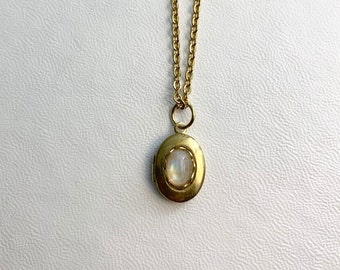 SMALL Antique brass LOCKET with Moonstone cabochon in a lace edged setting on 16&quot; necklace.  Perfect for Layering.