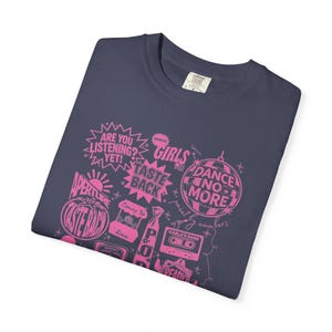 May include: Navy blue t-shirt with a pink graphic design featuring phrases like "ARE YOU LISTENING?" and "DANCE NO MORE." The design includes a disco ball, a cassette tape, and the words "AMERICAN GIRLS."