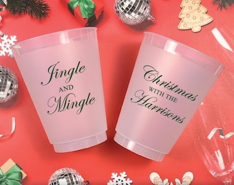 May include: Two frosted plastic cups on a red background. The left cup features dark green text reading Jingle AND Mingle. The right cup features dark green text reading Christmas WITH THE Harrisons. The cups are surrounded by holiday decorations.