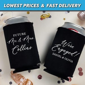 May include: Two black can coolers with white text. One cooler says "Future Mr. & Mrs. Collins" and the other says "We're Engaged! Daniel & Olivia".
