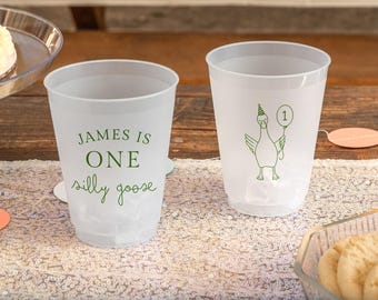 May include: Two translucent plastic party cups. One cup features green text that reads "JAMES IS ONE silly goose". The other cup displays a green line drawing of a goose wearing a party hat and holding a balloon with the number one inside.