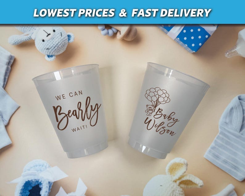 Puede incluir: Dos vasos de pl&aacute;stico transparentes con texto marr&oacute;n. Un vaso dice "We can Bearly Wait!" y el otro vaso dice "Baby Wilson" con un peque&ntilde;o oso sosteniendo globos.