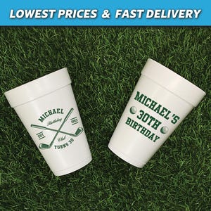 May include: Two white foam cups with green golf-themed designs. One cup says "Michael's 30th Birthday" with two golf balls. The other cup says "Michael Birthday Est 1993 Club Turns 30" with two crossed golf clubs.
