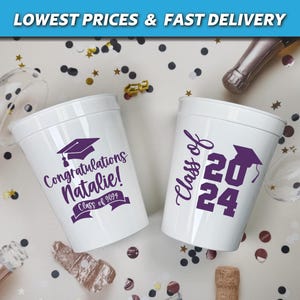 May include: Two white plastic cups with purple graduation designs. One cup says "Congratulations Natalie! Class of 2024" and the other says "Class of 2024".
