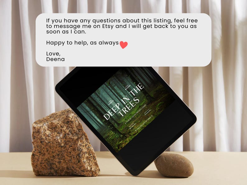 May include: A black tablet computer displaying a book cover with the title "Deep in the Trees" on a light brown surface with two rocks. The text on the tablet reads: "If you have any questions about this listing, feel free to message me on Etsy and I will get back to you as soon as I can. Happy to help, as always. Love, Deena."