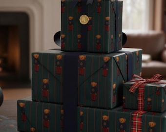 May include: A stack of wrapped gifts with a dark green background and a repeating pattern of teddy bears in red outfits. The gifts are tied with navy blue and red ribbons. A pair of scissors and wrapping paper are on the table.