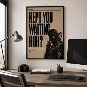 May include: A rectangular wall poster featuring a tan background with black text that reads "SOLID SNAKE", "KEPT YOU WAITING HUH?", and "METAL GEAR SOLID 1998". The poster displays a black illustration of a character smoking a cigarette.