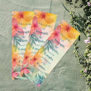 May include: Three floral bookmarks with a watercolor design. The bookmarks feature a quote from Proverbs 31:25: "She is clothed with strength and dignity, and she laughs without fear of the future."