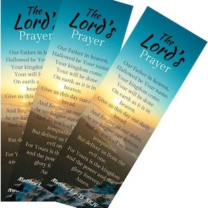 May include: Three bookmarks with a sunset background and the Lord's Prayer printed in black text. The text includes the words "Our Father in heaven, Hallowed be Your name, Your kingdom come, Your will be done, On earth as it is in heaven, Give us this day our daily bread, And forgive us our debts, As we forgive our debtors, And do not lead us into temptation, But deliver us from the evil one, For Yours is the kingdom and the power and the glory forever. Amen." The bookmarks also include the text "Matthew 6:9-13 NKJV".